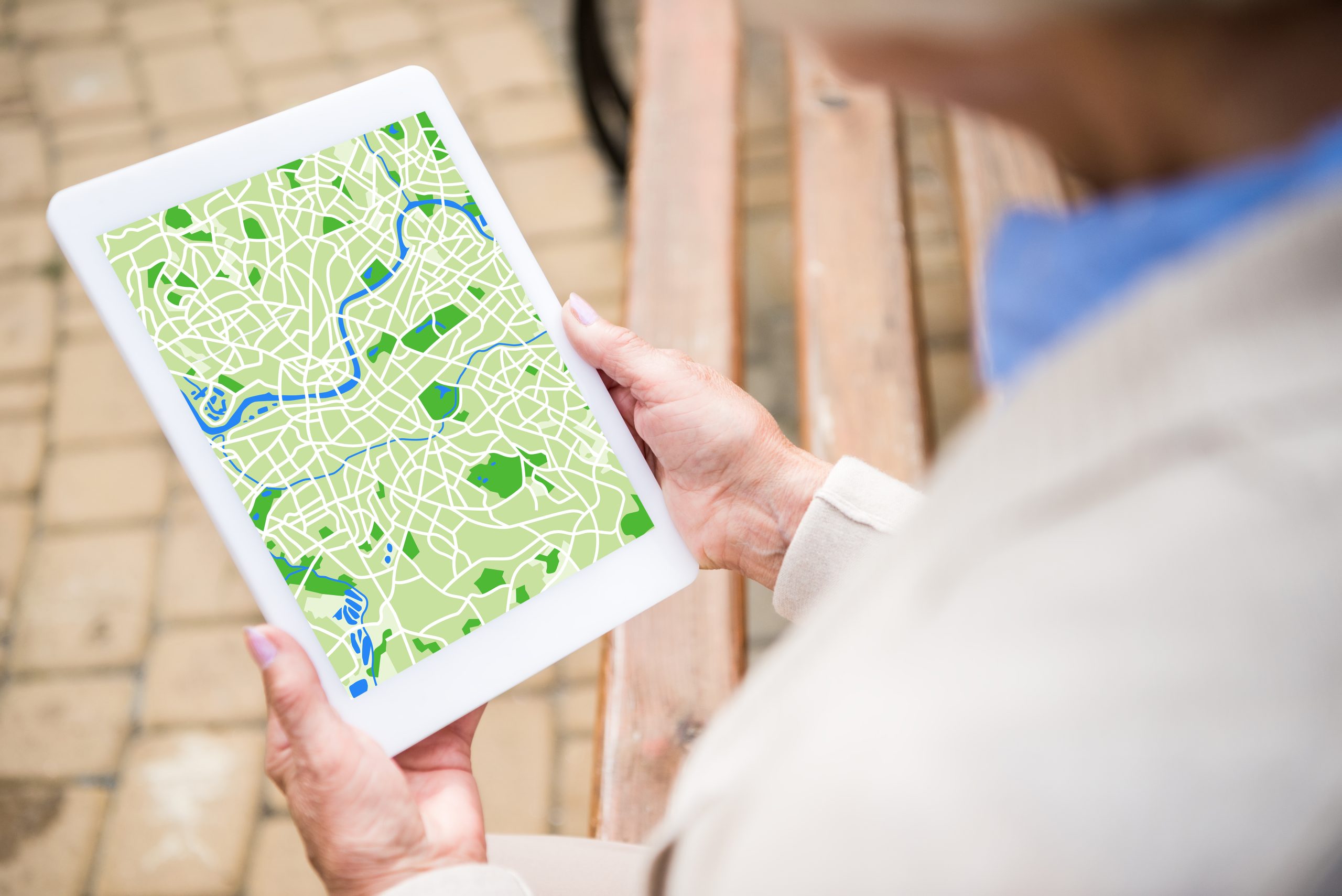 selective focus of senior woman using digital tablet with map on screen